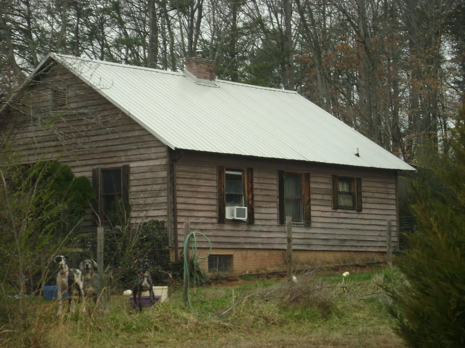 White metal roof on an old wood sided farmhouse, from a Metal Roof Installation job in Monkton